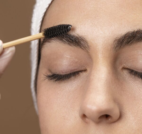 woman-doing-eyebrow-treatment-her-client